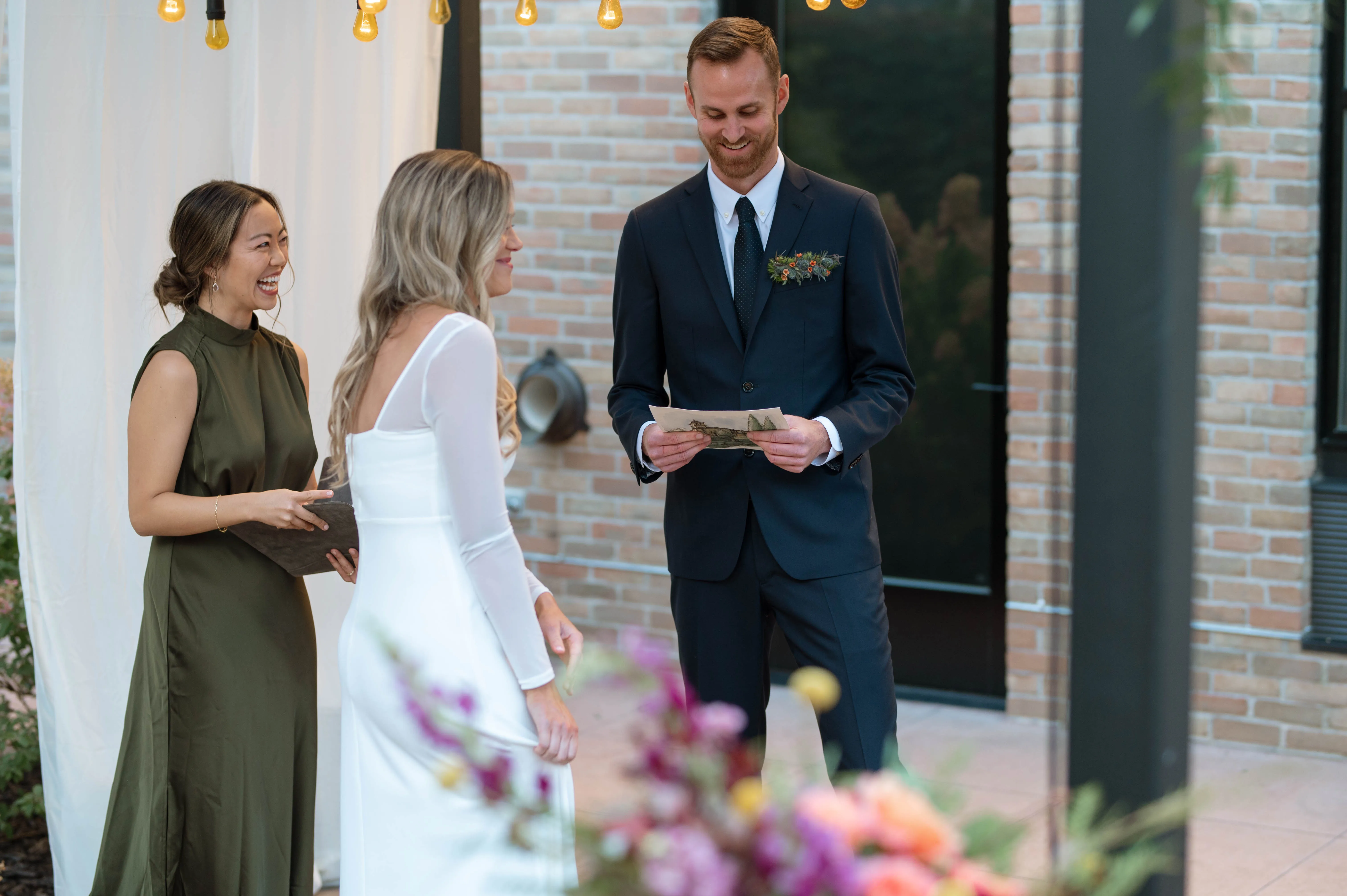 Mitchell reading his vows beneath the pergola