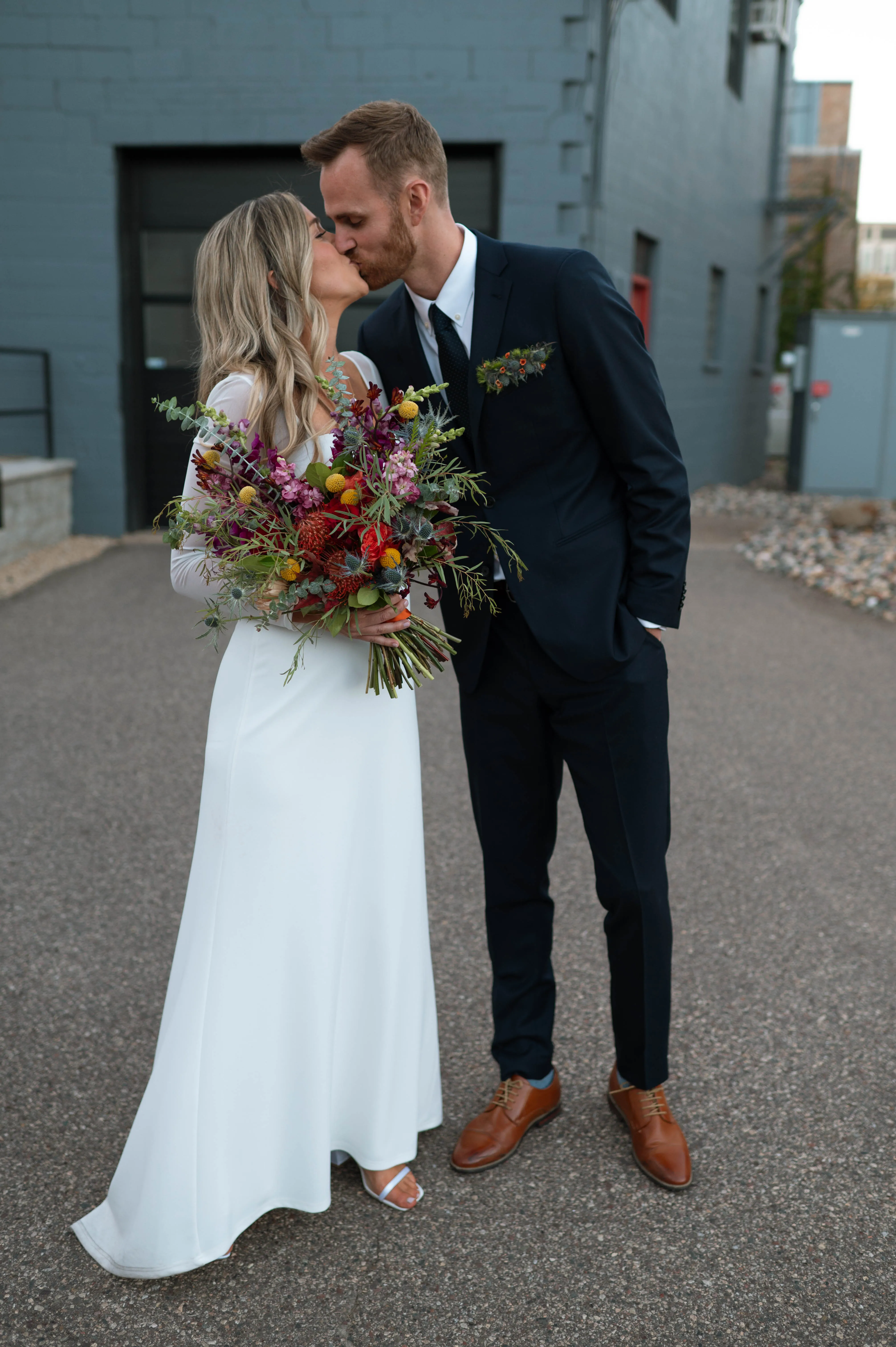 A full-length kiss in a sunlit alley near Hotel Crosby