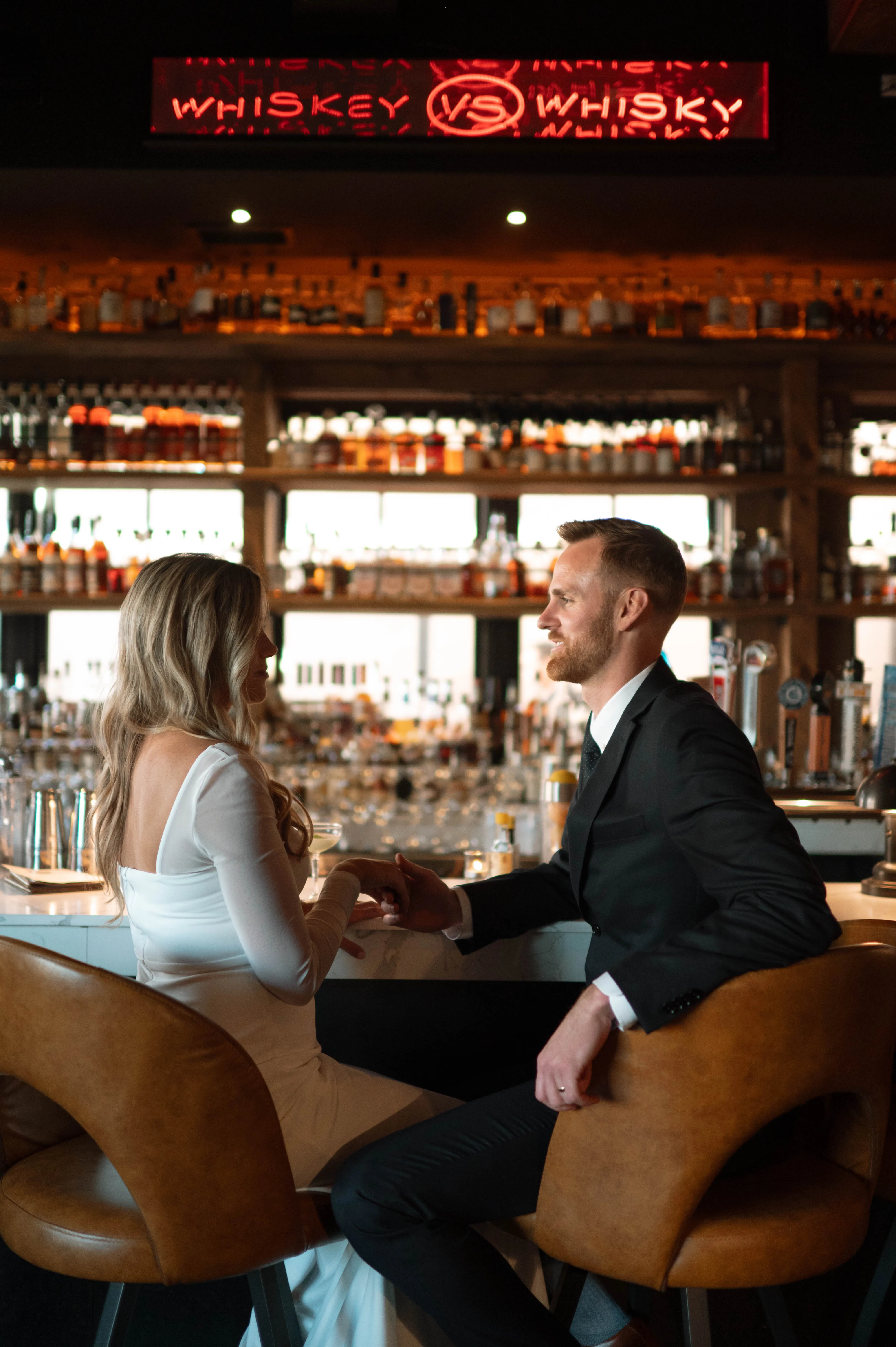 Shannon and Mitchell seated at the whiskey bar for portraits