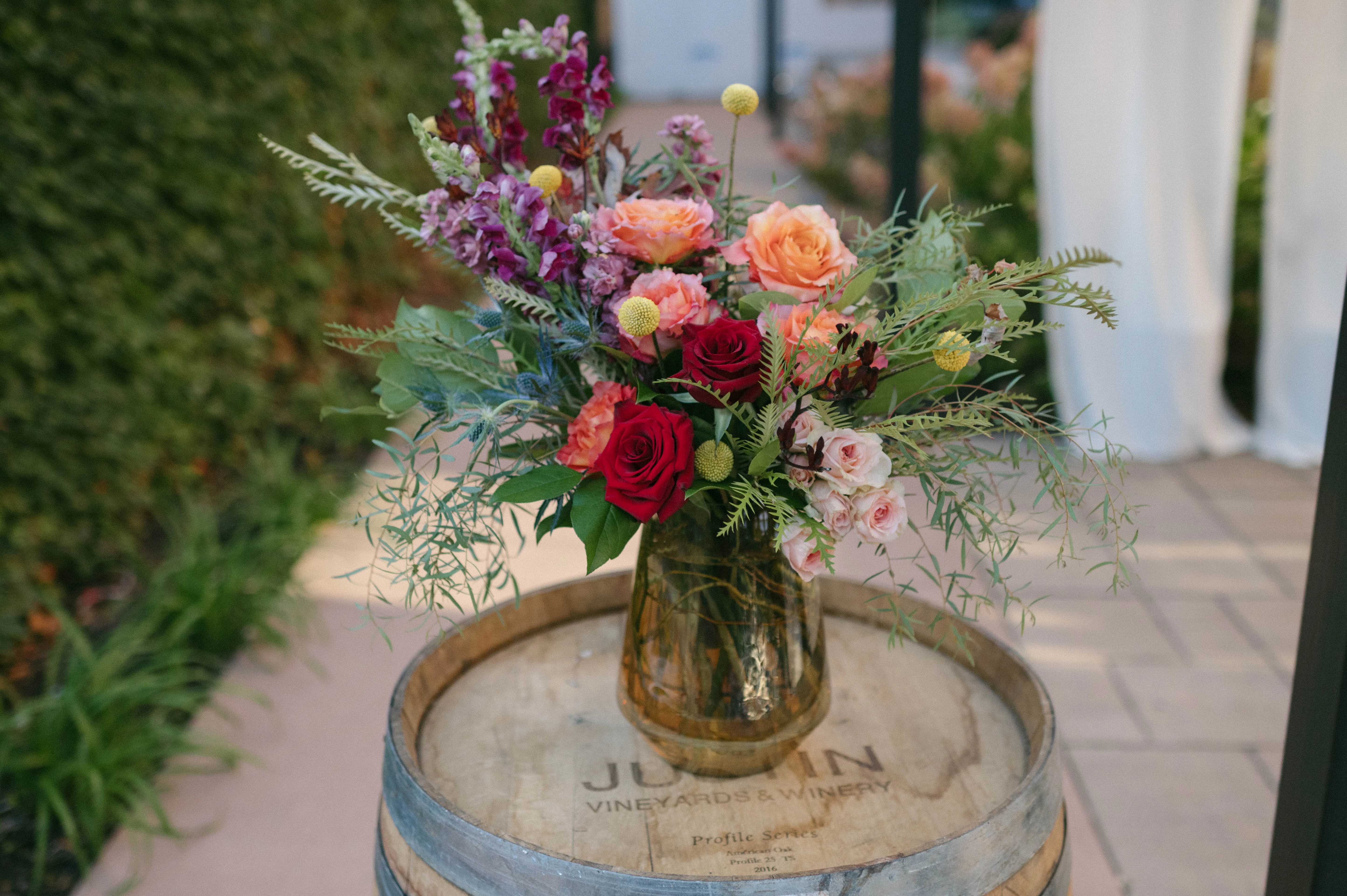 A garden-gathered arrangement styled on a wine barrel