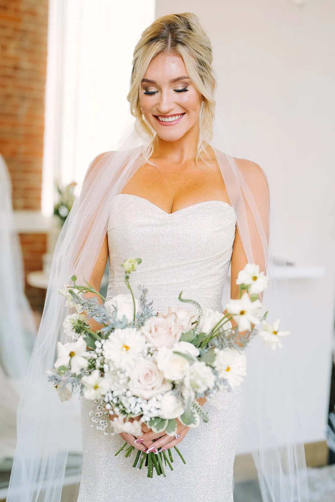 Claire in her veil, bouquet held close, in a quiet portrait moment
