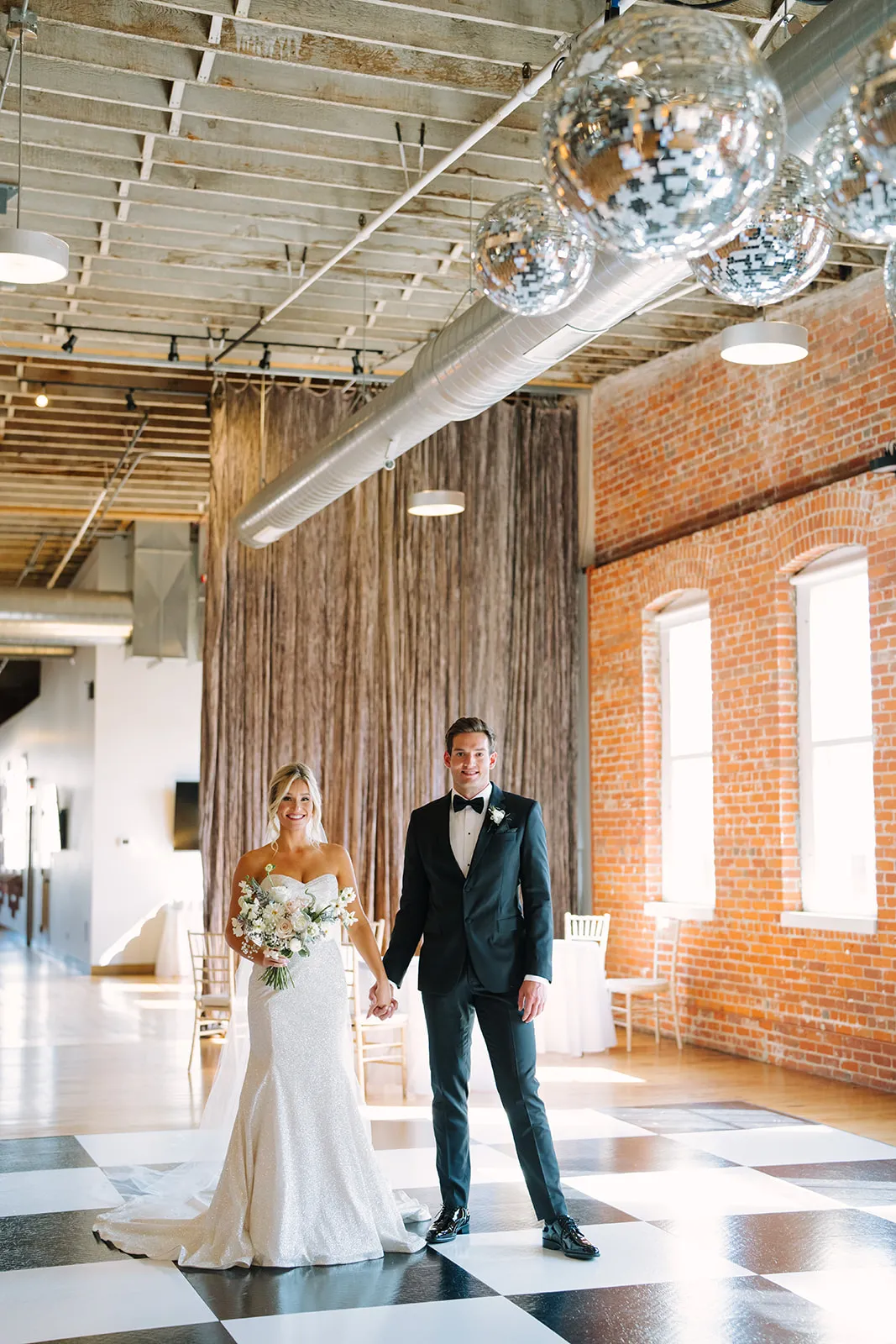 Claire and Connor on The JX's checkered dance floor beneath hanging disco balls