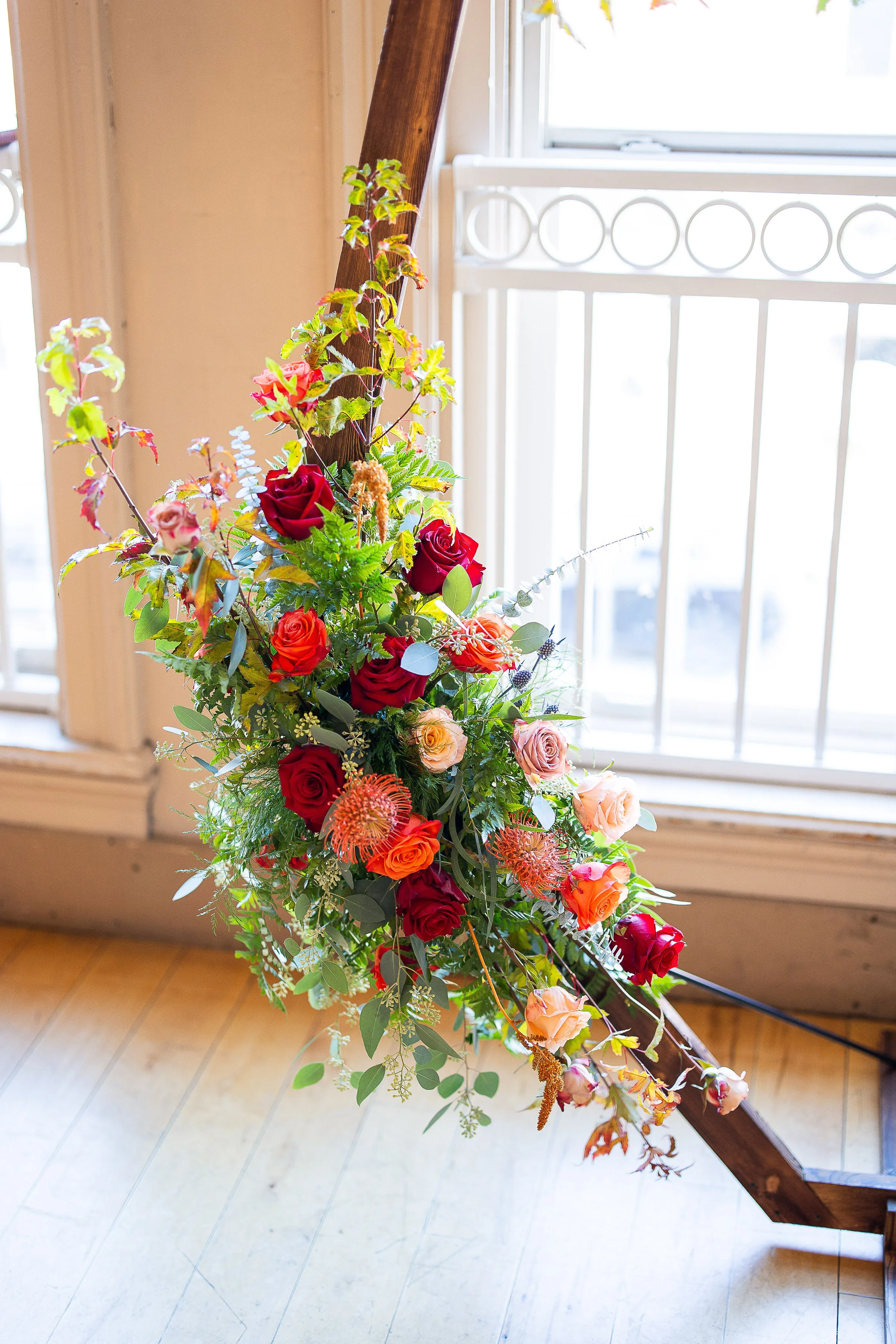 Detail of the hexagon arbor's corner, roses and eucalyptus trailing against Loft 214's arched window