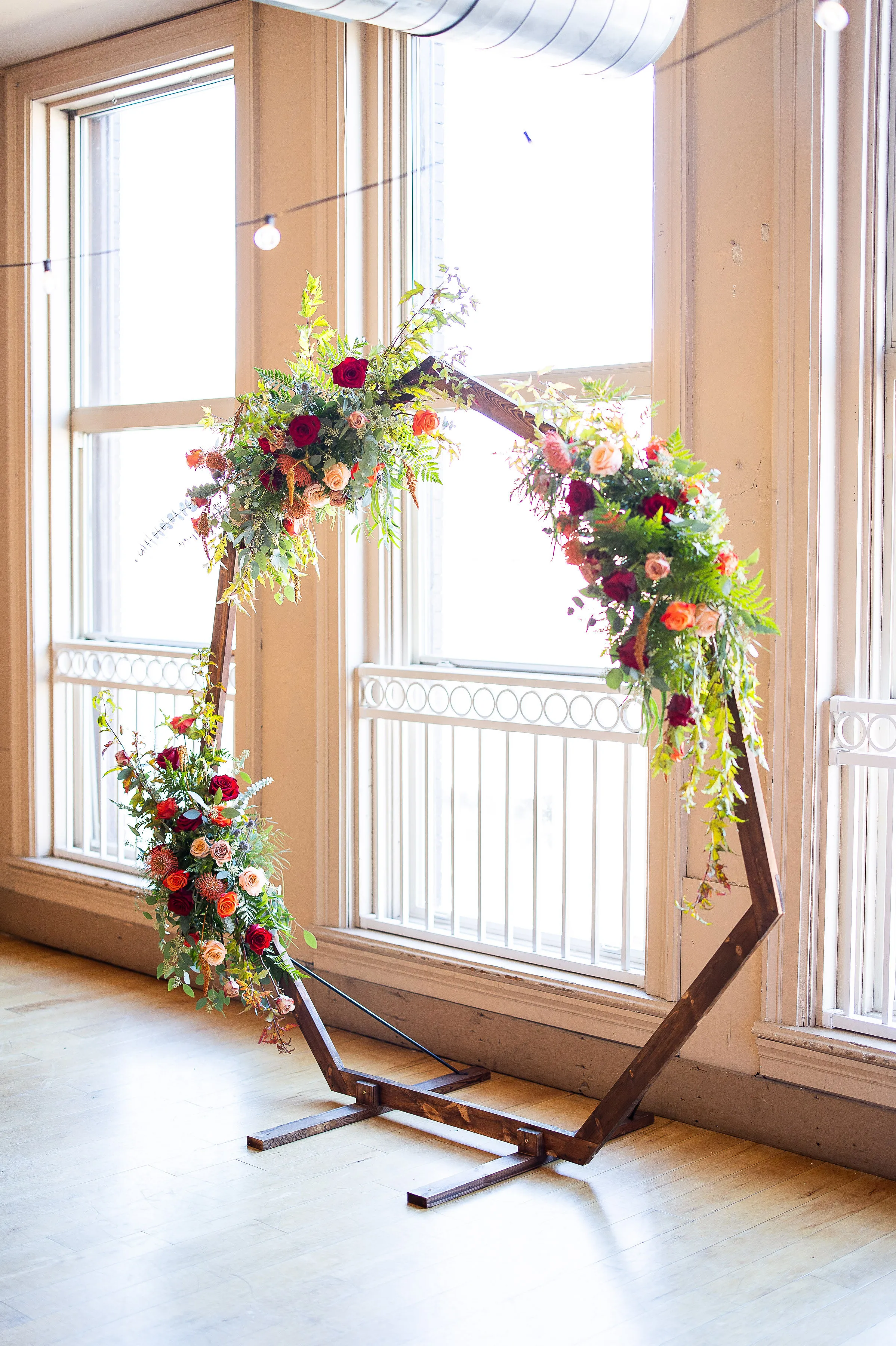 Hexagon ceremony arbor with floral arrangement at Loft 214, Stillwater