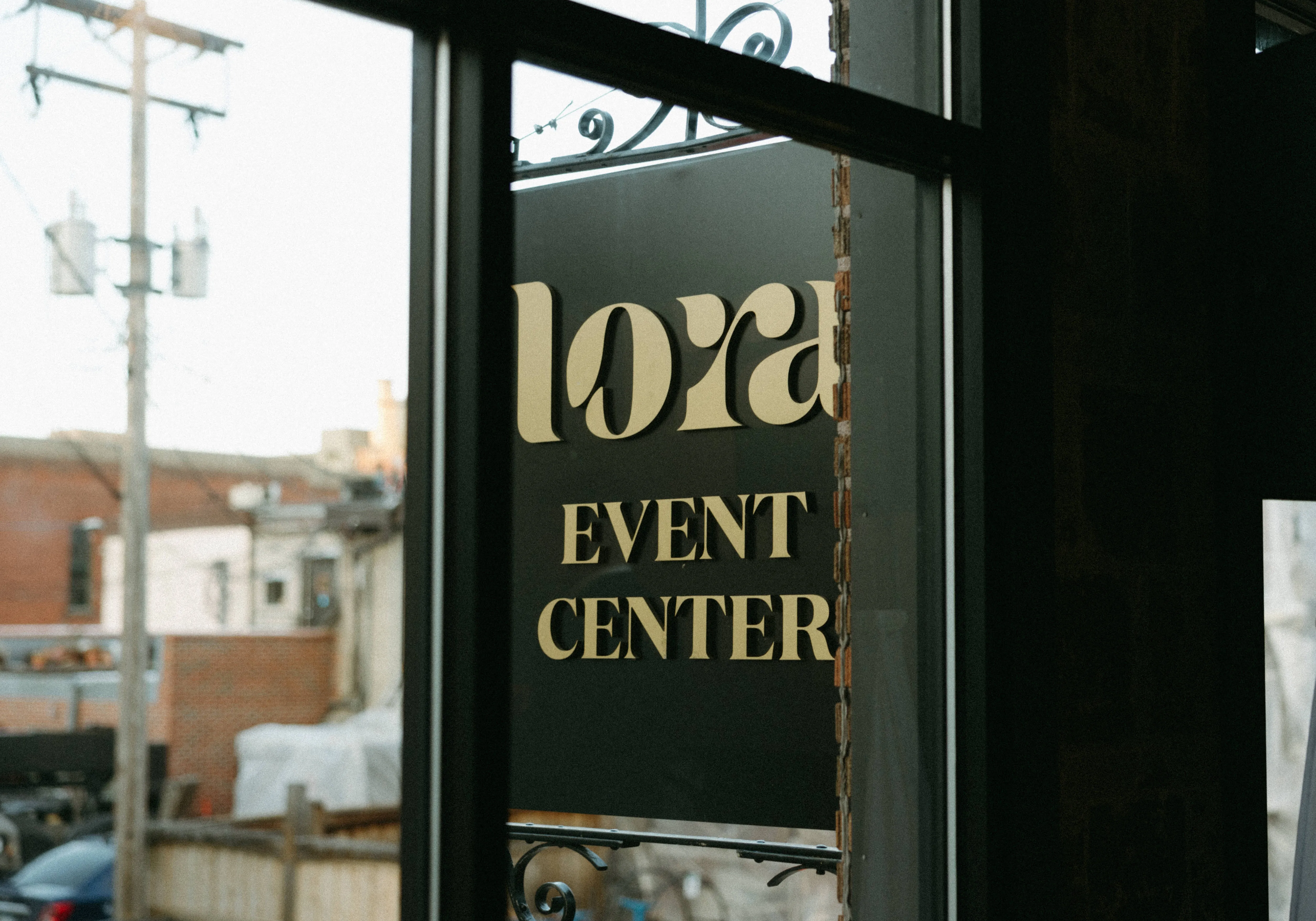 The Lora Event Center's signage, seen through the venue's front window