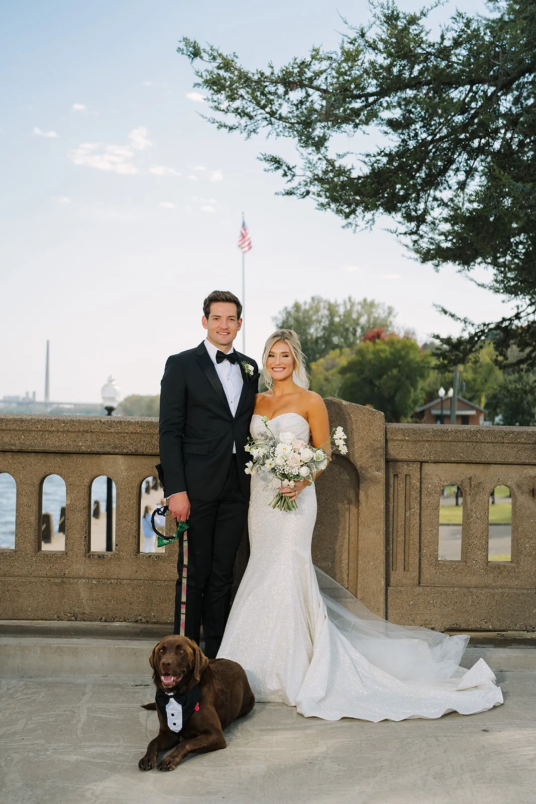 Claire and Connor with their chocolate lab on Stillwater's historic lift bridge