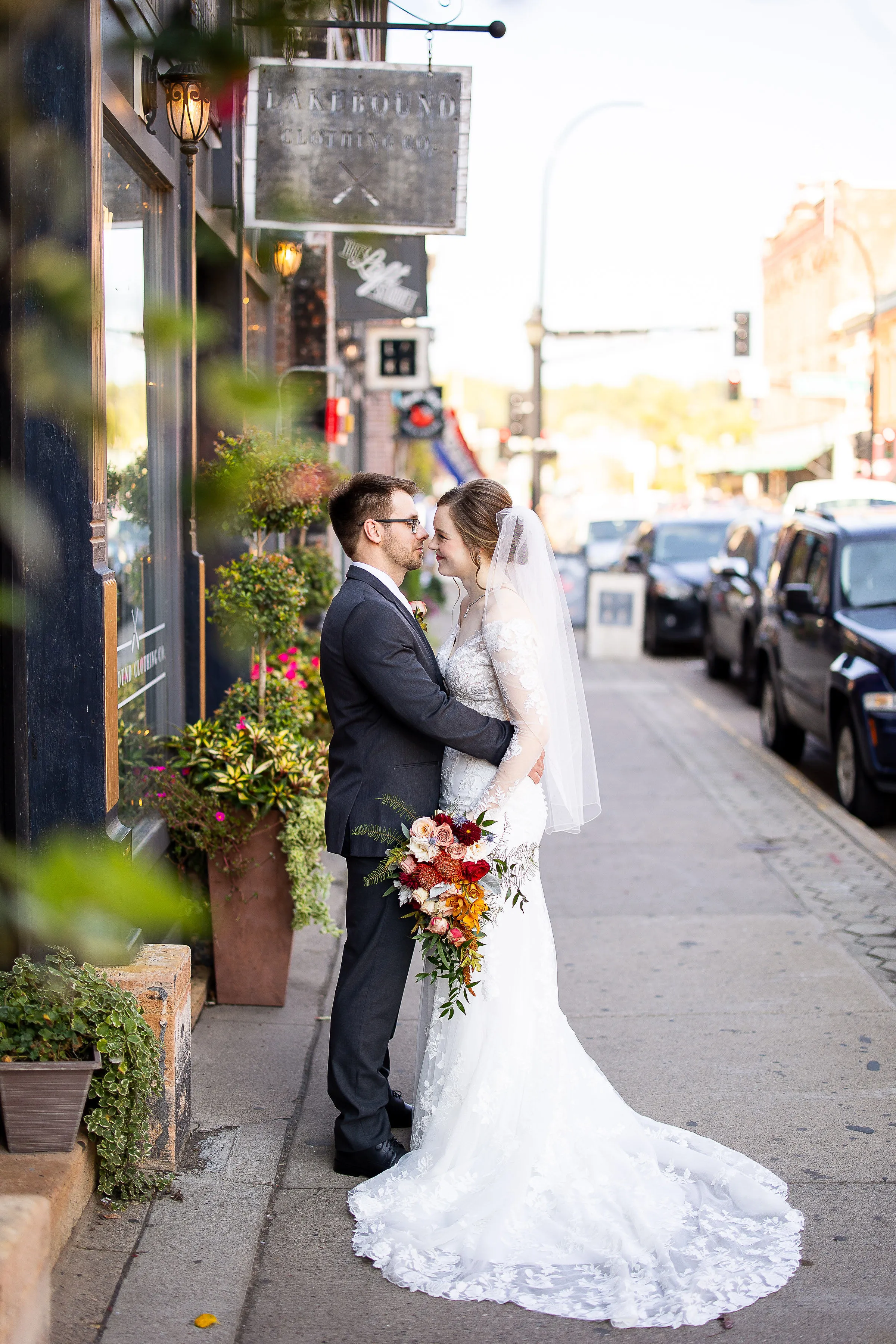 Angela and Nick share a quiet moment outside a storefront in historic downtown Stillwater